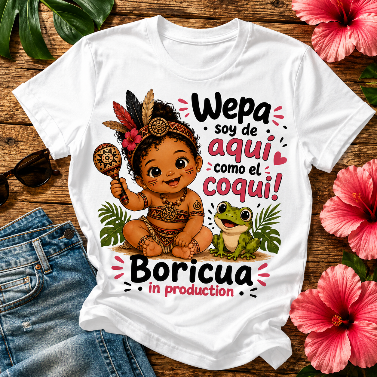 Boricua in Production pregnancy announcement T-shirt featuring a Taíno-inspired baby, coquí frog, and Puerto Rican cultural artwork.