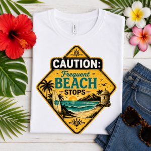 Caution Frequent Beach Stops T-shirt featuring a vintage tropical beach road sign with palm trees, surfboard, ocean waves, mountains, and Puerto Rican coastal scenery.
