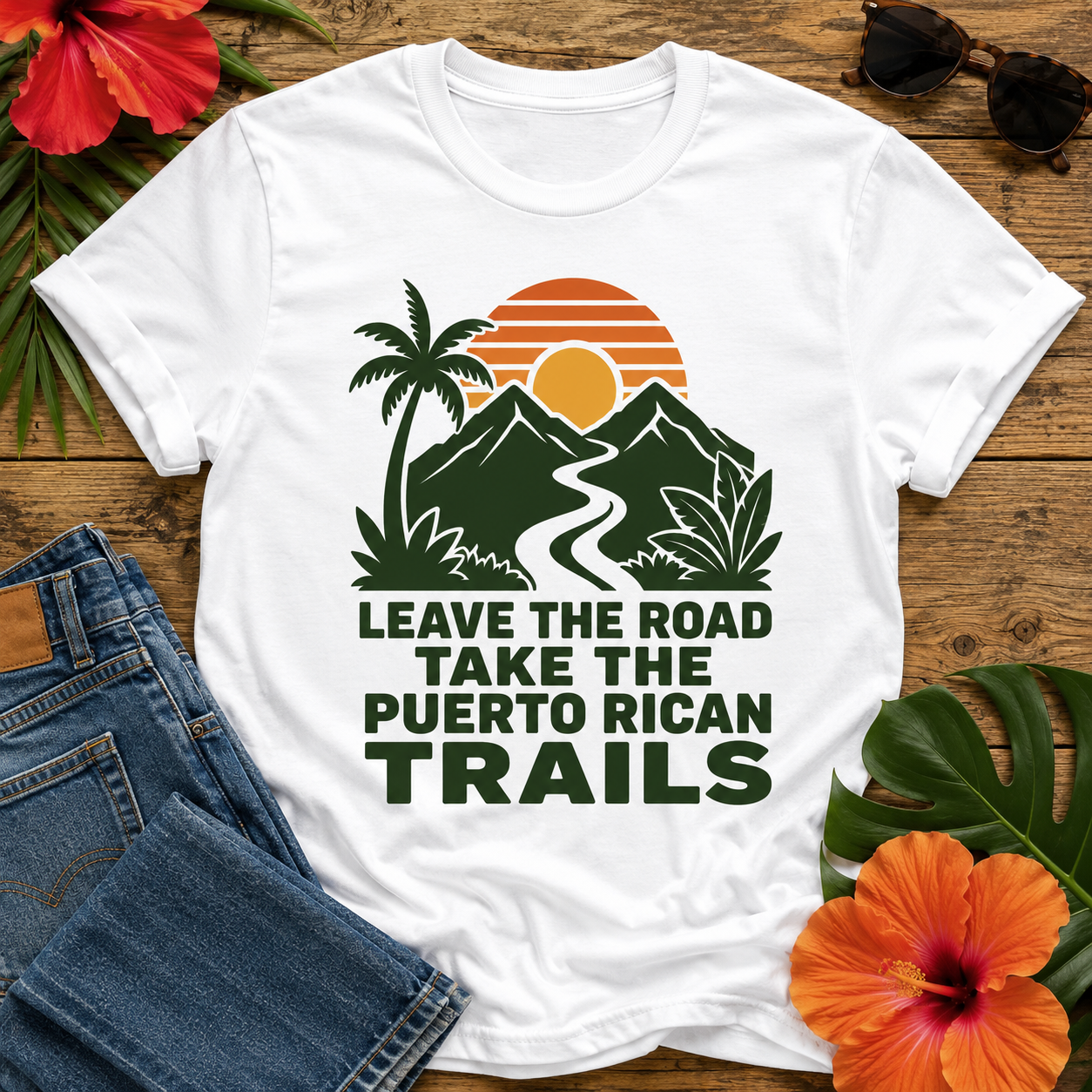 Puerto Rican Trails T-Shirt featuring a retro sunset, tropical mountains, palm tree, and the quote "Leave the Road, Take the Puerto Rican Trails"