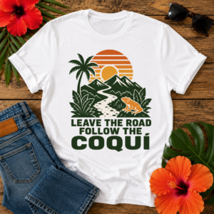 Coquí Sunset T-Shirt featuring a tropical sunset, mountains, palm tree, coquí frog, and the quote "Leave the Road Follow the Coquí"