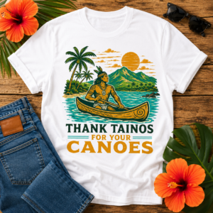 Taino Canoe T-Shirt featuring a Taíno paddling a traditional canoe with tropical mountains, palm trees, and the quote "Thank Tainos For Your Canoes"